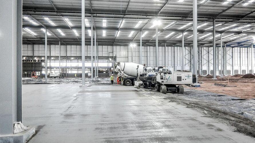 Concrete placement Aldi floor slab Freshly placed floor slab at Aldi distribution centre using steel fibre reinforced concrete.