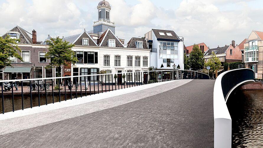 Catharina Bridge UHPC railing view Catharina Bridge with curved UHPC railing and view of historic city buildings.